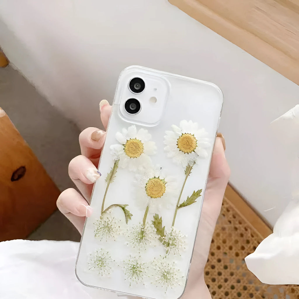 White TPU iPhone case with epoxy daisy floral pattern on back, shown on iPhone model