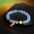 Geometric women's bracelet with 8mm iced aquamarine stones on a wrist.