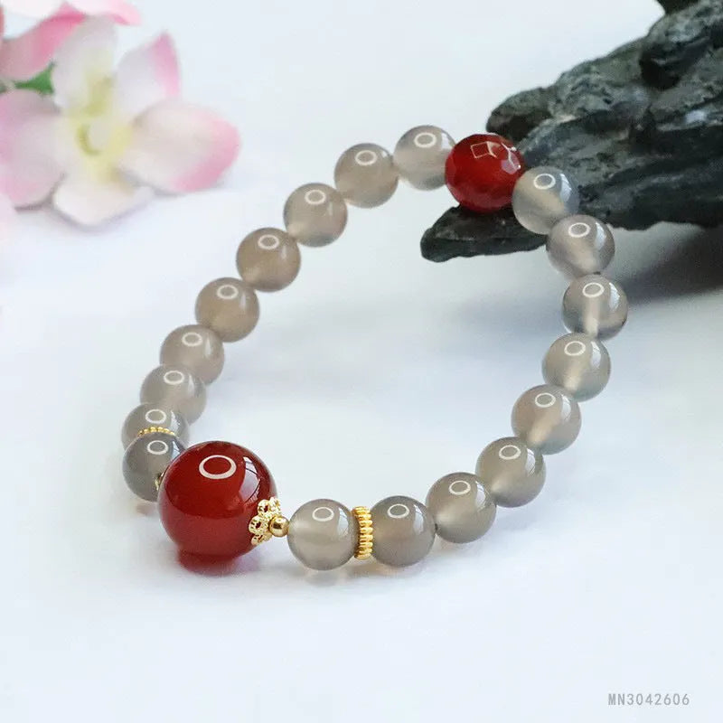 Smoky purple chalcedony red agate bracelet with 8mm geometric beads on a wrist.