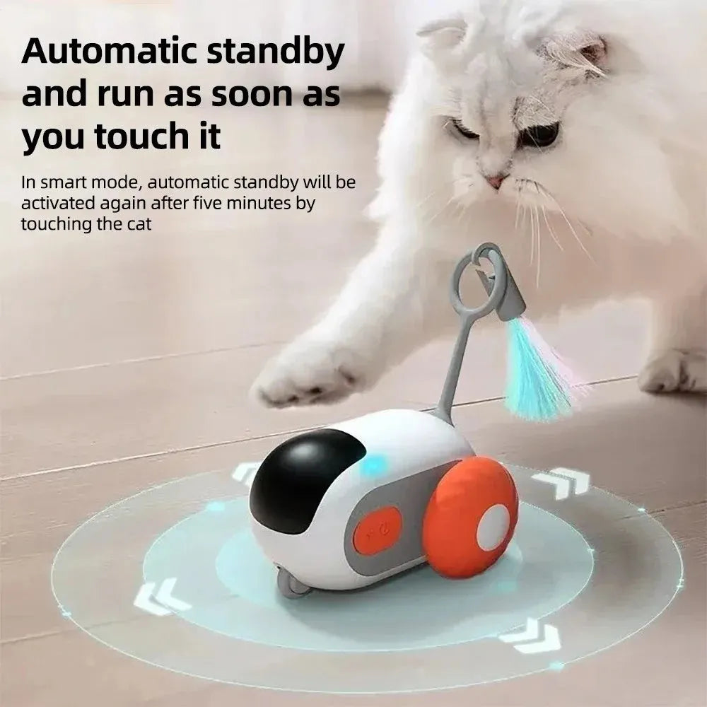 Blue smart cat toy car with feather teaser and remote control on a wooden floor