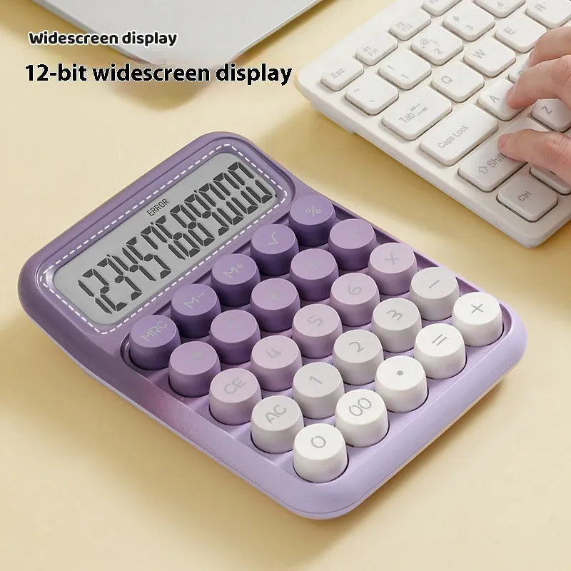 Round mechanical keyboard calculator in a muted colour with large LCD display on desk.