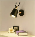 Modern antler bedside wall lamp in black iron and wood, 24x29cm with E27 bulb base.