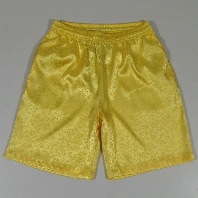 Men's black Tai Chi shorts with an elastic drawstring waistband on a white background.