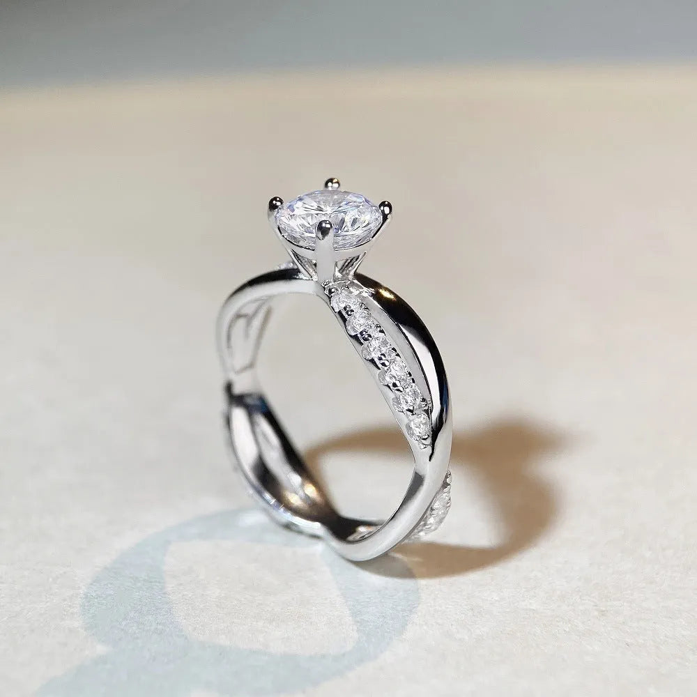 Silver ring with twisted band and 1 carat moissanite stone in four-claw setting