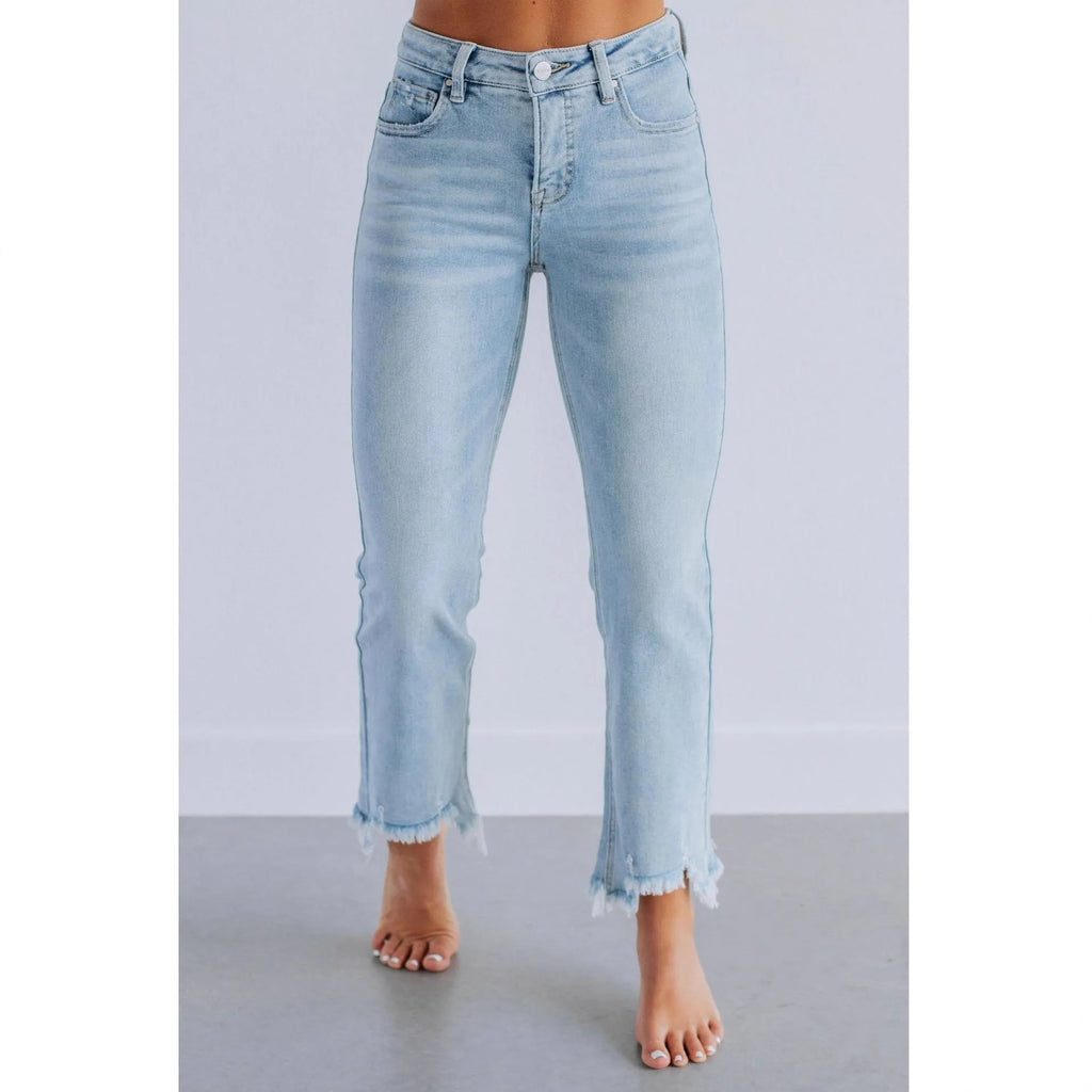 Women's solid blue casual denim trousers with a hand-worn finish on a hanger.
