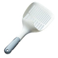 White plastic cat litter scoop with an integrated storage base on a flat surface.