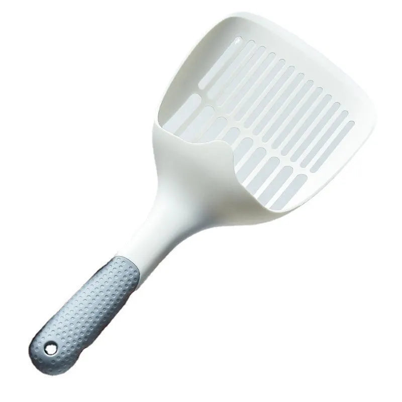 White plastic cat litter scoop with an integrated storage base on a flat surface.
