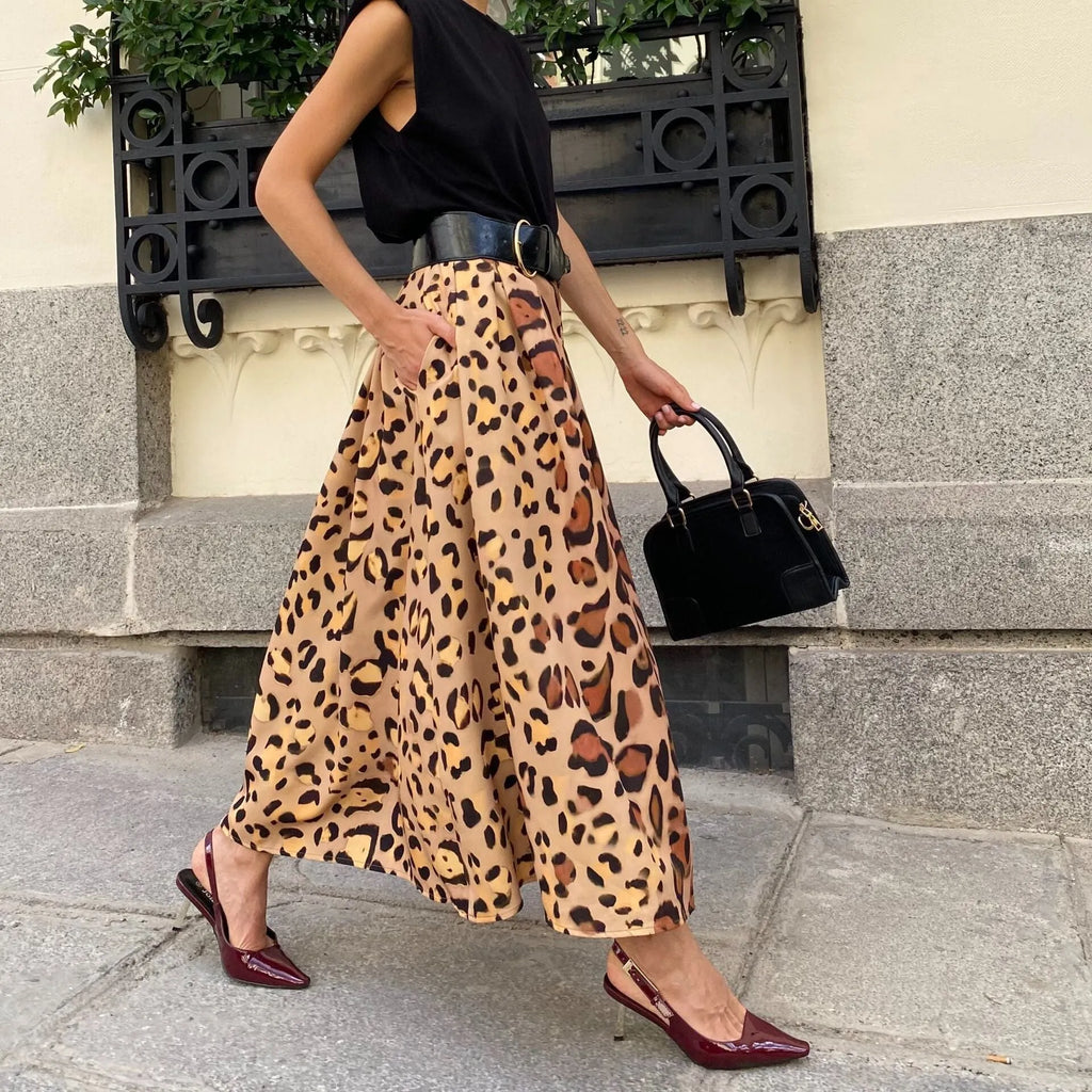 Brown leopard print women's A-line long skirt with a big hem on a model.