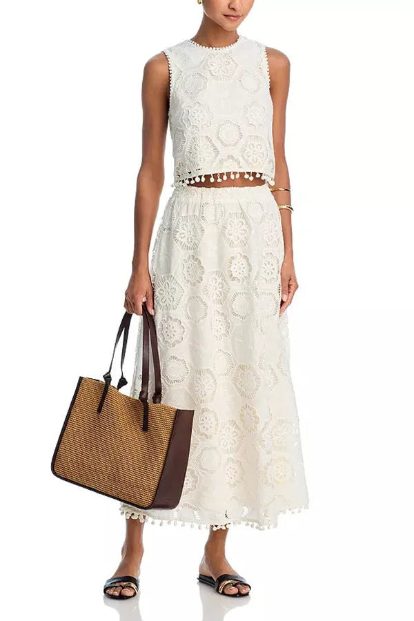 White women's polyester two-piece suit with embroidered detailing, featuring a sleeveless top and a long skirt.