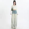 A pair of women's gradient blue wide-leg denim trousers on a neutral background.