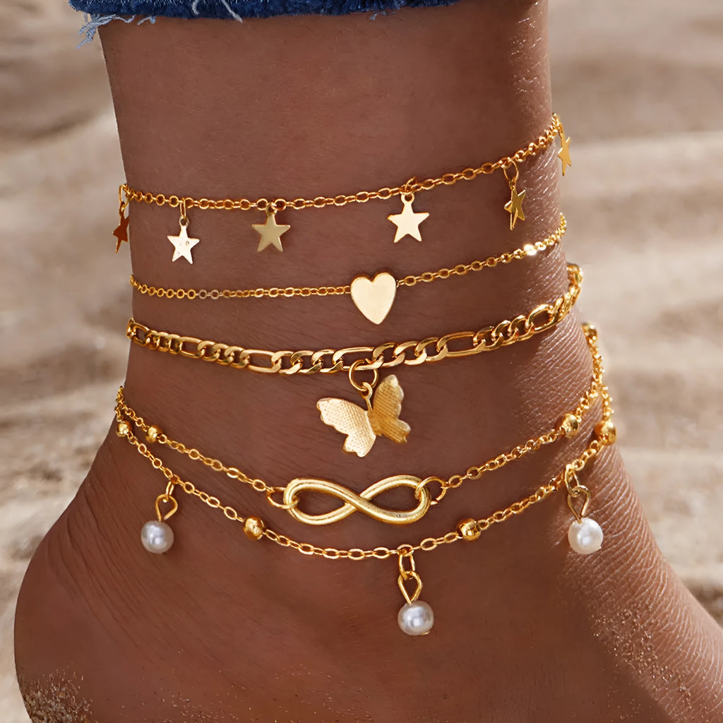 Four-piece women's alloy anklet set with butterfly and pearl heart charms in multi-layer design