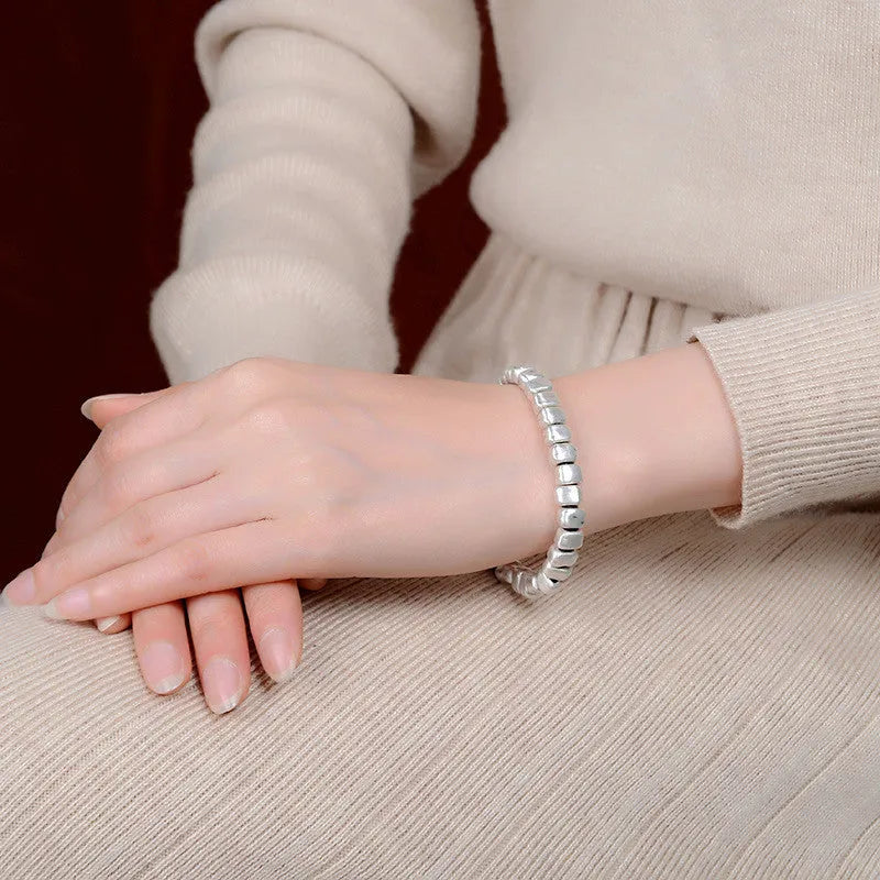 Handmade silver women's bracelet with wooden accents and irregular square design