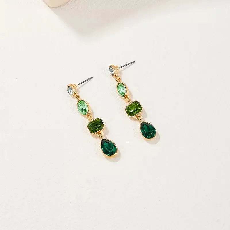 Female green round tassel long geometric earrings on display showing round acrylic and tassel drop