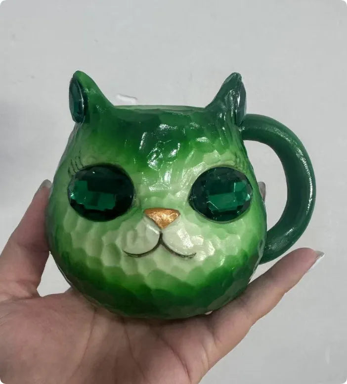 Clear resin Cat Cup ornament in purple, green, blue, and pink colour options on display.