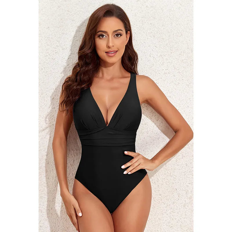 Minimalist solid colour cross-shoulder one-piece swimsuit for women on a mannequin.