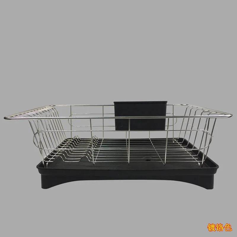Black stainless steel dish drying rack with plastic cutlery holder and drain board on a kitchen counter.