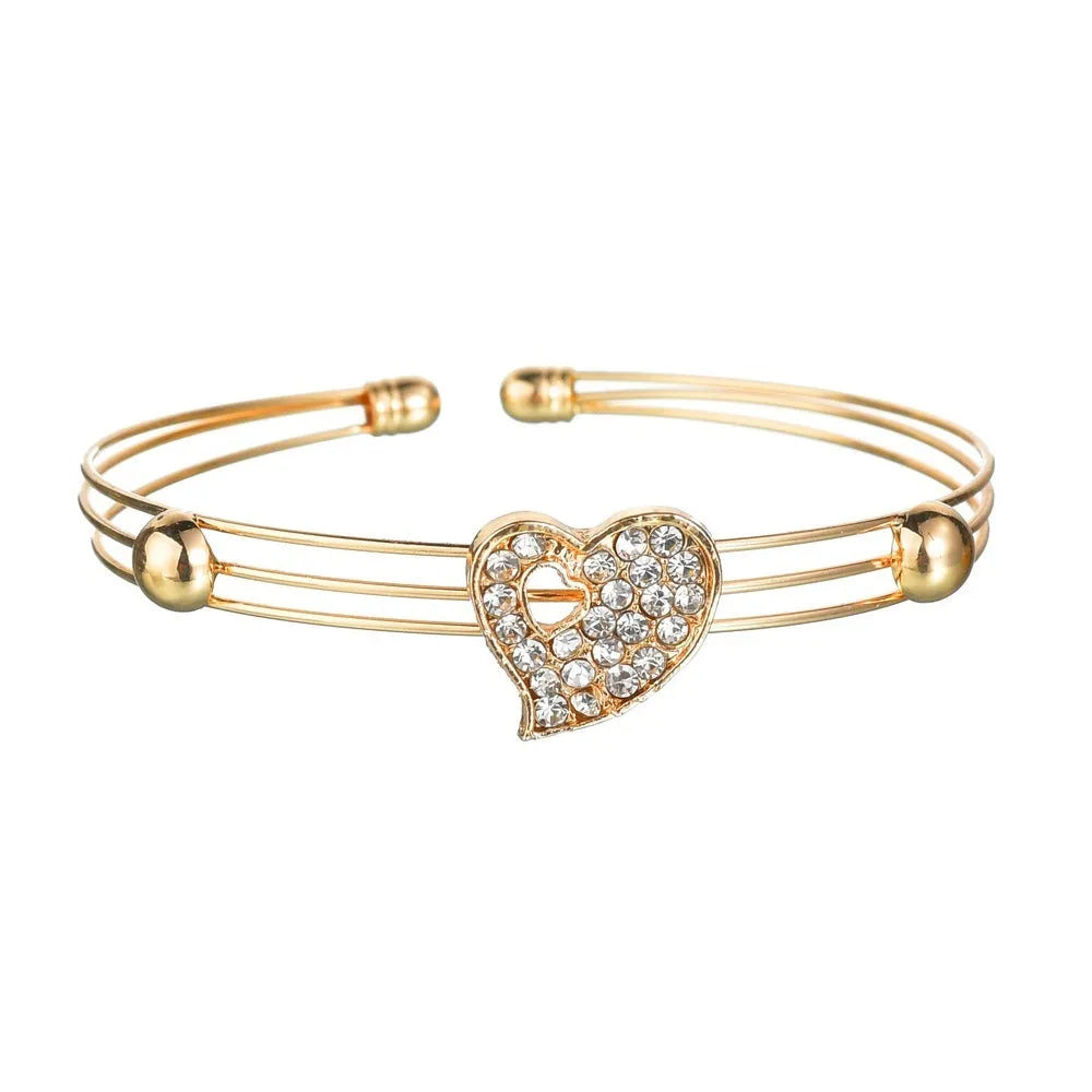 Gold tone alloy jewellery set with earrings, pendant and bracelet featuring love, water drop or bell patterns