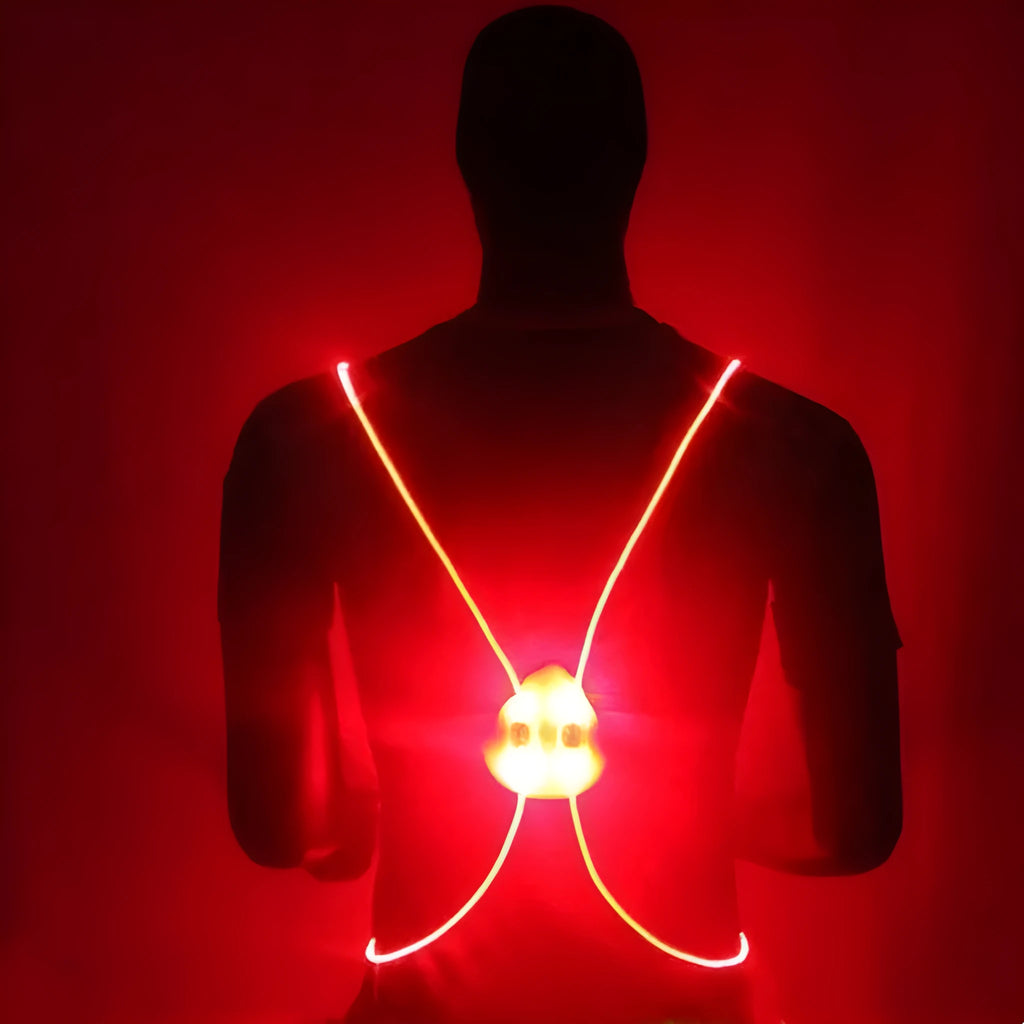 Red reflective vest with LED fibre optic lights visible on a person cycling at night