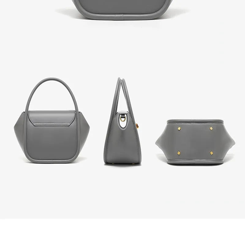 Women's leather wing tote bag in cow leather with a cross-body strap and buckle detail.