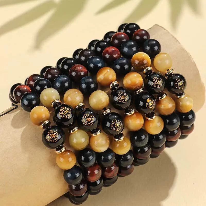 Handmade black agate bracelet with zodiac animal charms and gold tiger eye beads on wrist