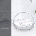 Wireless charging LED night lamp with Bluetooth speaker in marble pattern finish showing phone on charging surface
