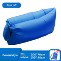 Inflatable portable sofa in a colourful design, shown folded to its 36cm by 27cm size and in use outdoors.