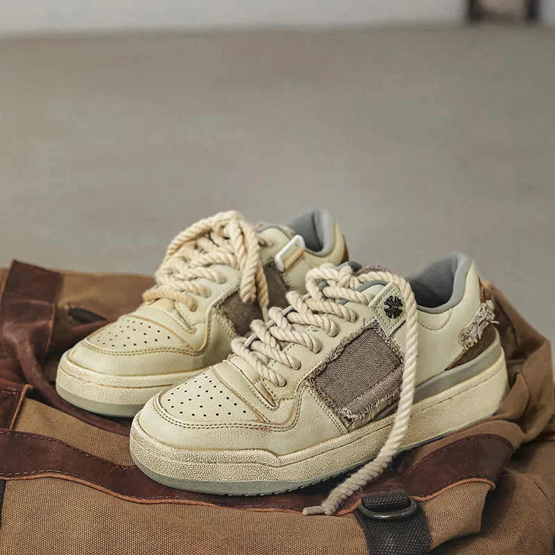 Beige low-top vintage skateboard shoes with round toe and rubber sole on a white background