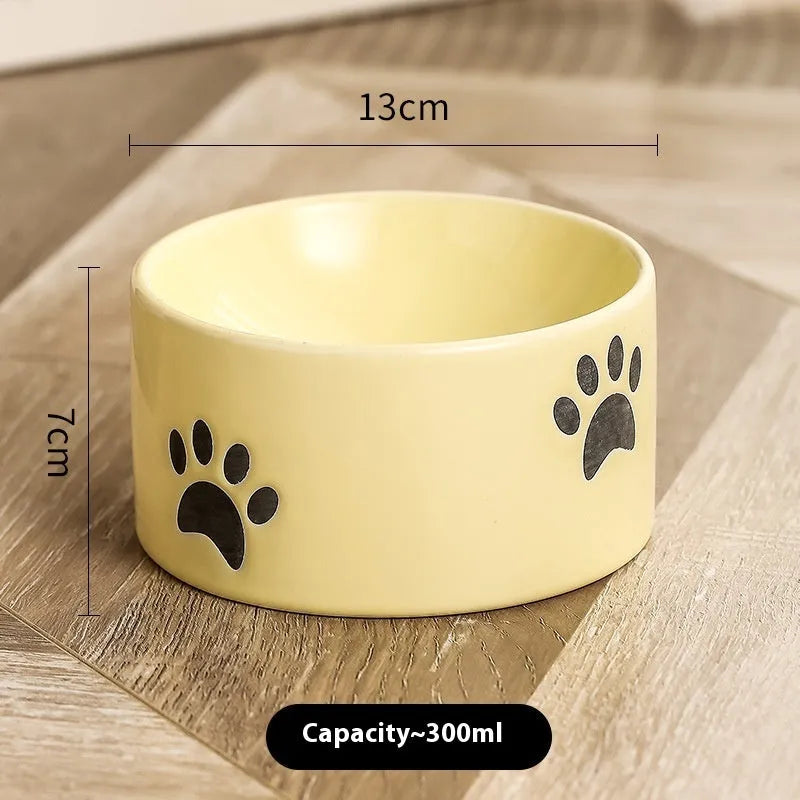 Ceramic cat bowl with high foot design and oblique mouth in cat's paw pattern