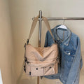 Women's nylon crossbody bag with double shoulder straps showing multiple pockets in black colour