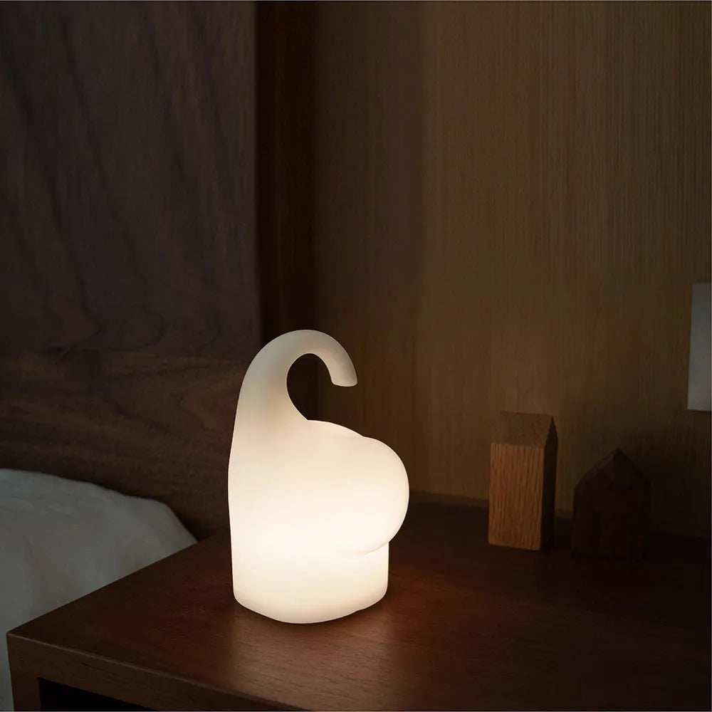 DOMI elephant-shaped silicone night light in warm white, showing its compact size.