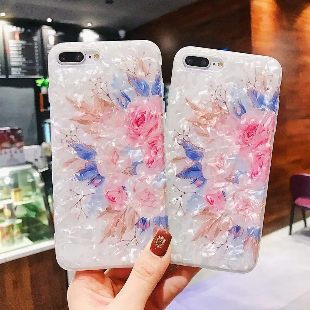 Dream Shell soft TPU iPhone case with rose flower pattern on back, shown in brown, purple and white.