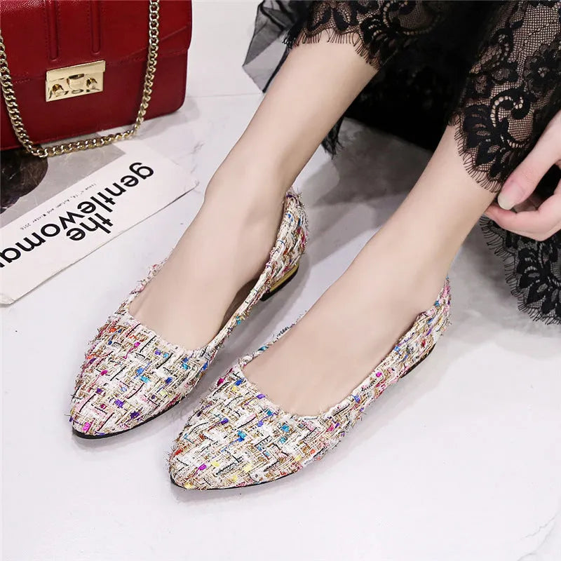 Women's black and white canvas flats with pointed toe and lace-up design