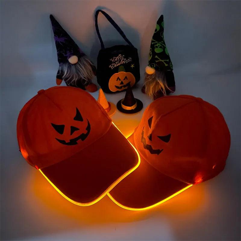 Halloween LED light-up baseball cap showing pumpkin smile yellow light pattern on a black cloth cap with adjustable strap.