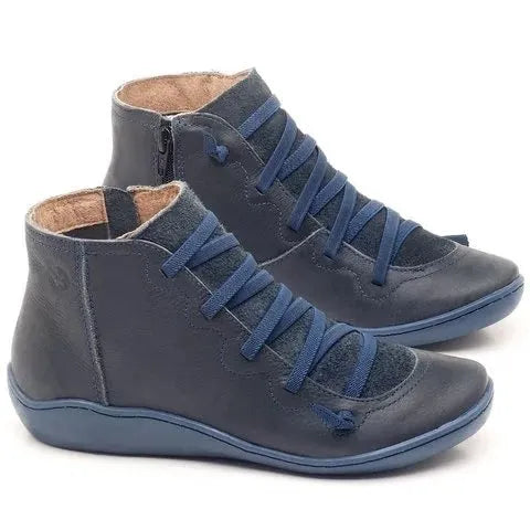 Women's black casual booties with round toe and low wedge heel on a rubber sole.