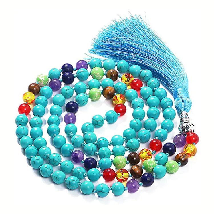 Long blue gemstone tassel necklace with agate, lapis lazuli, and turquoise beads on a geometric pendant.