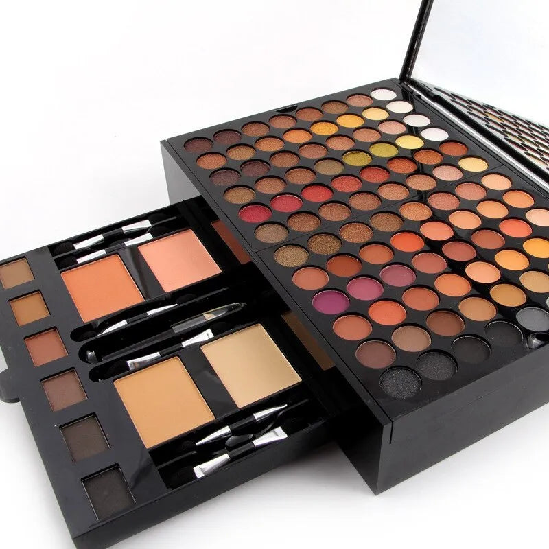 Piano-shaped open makeup palette displaying 180 eyeshadow colours, 2 blushes, 2 powders, and 6 powder outlines.