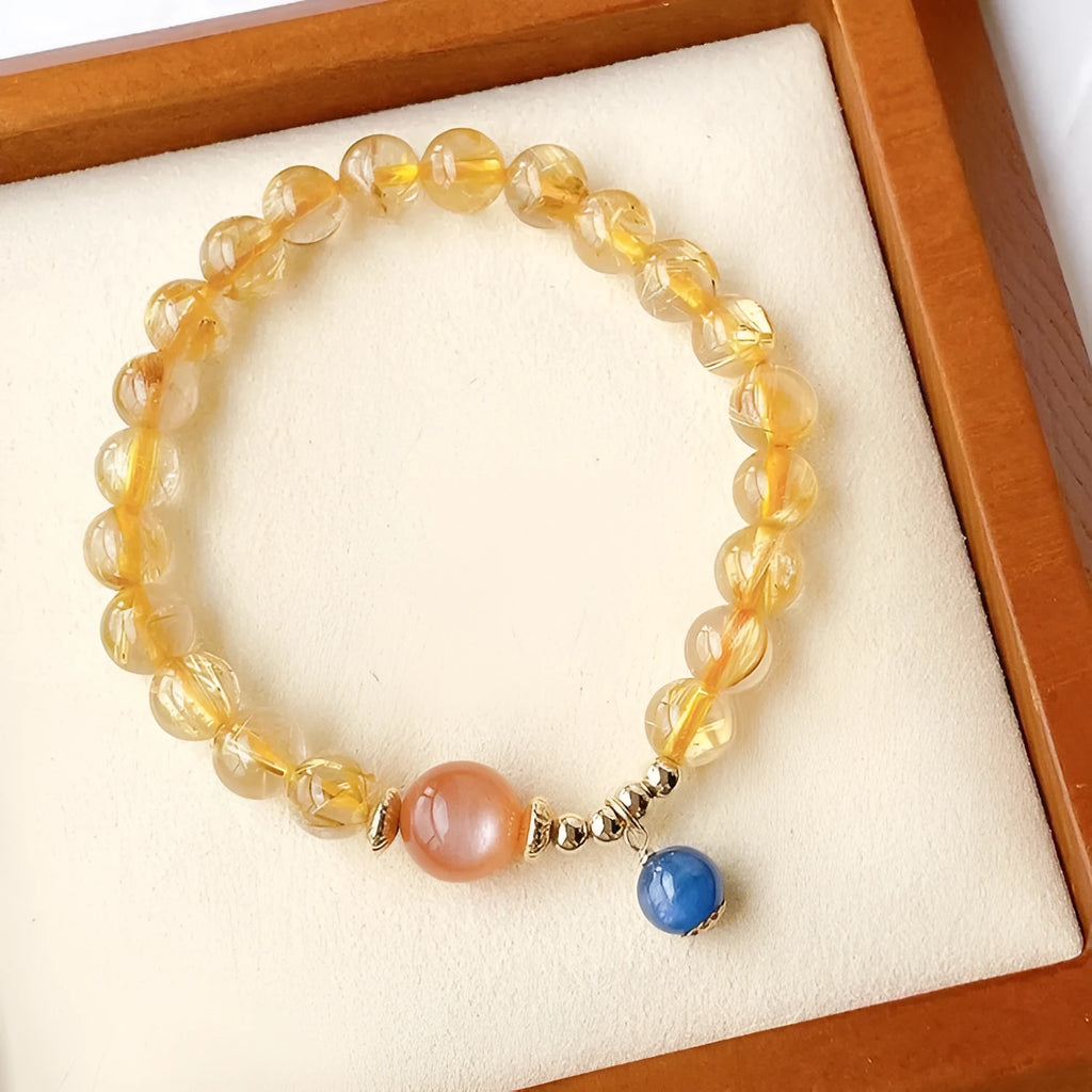 Gold rutilated quartz sunstone crystal bracelet with diamond-shaped beads for women.
