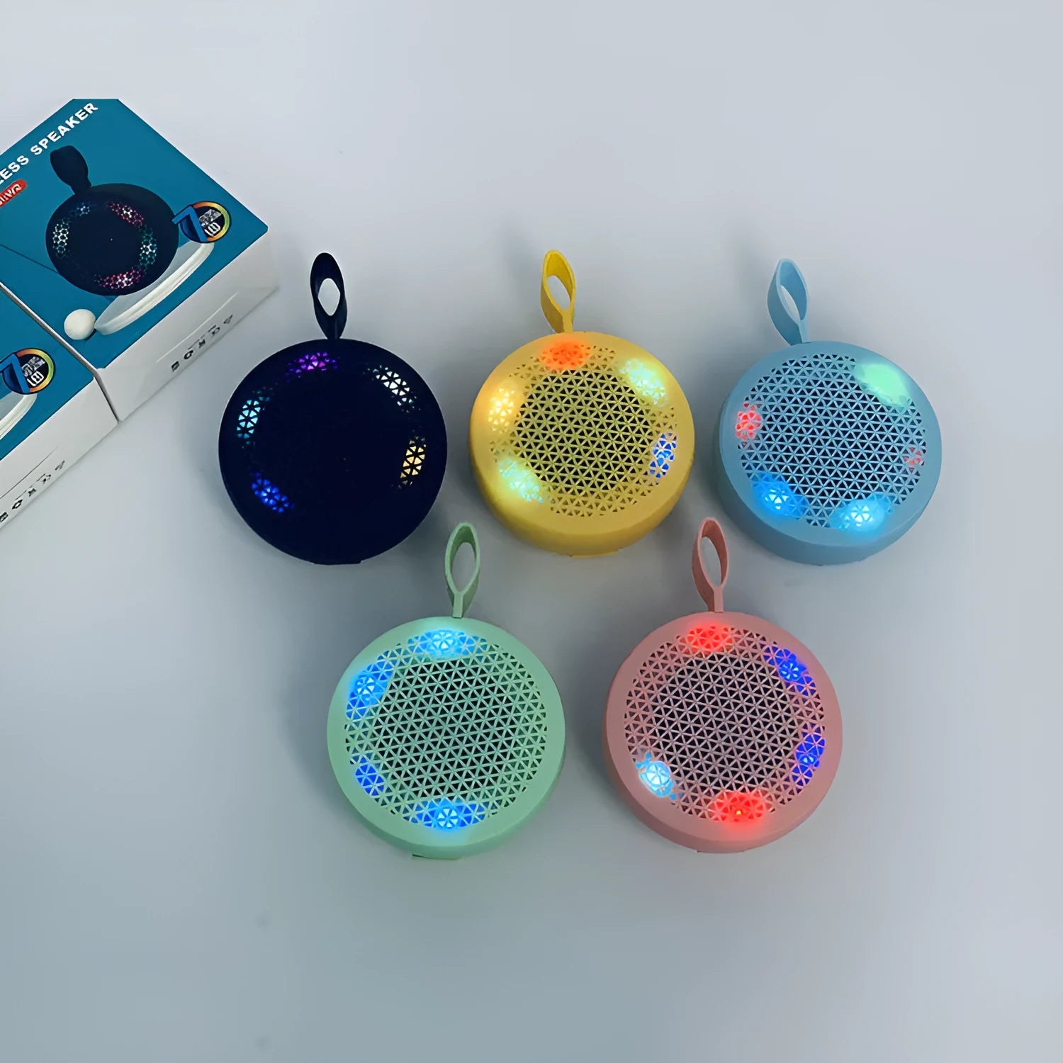 Pink mini Bluetooth speaker with plastic shell and button controls, 82x82x40mm