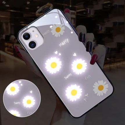 White iPhone case with painted purple daisies and voice-activated colour lights on the back.