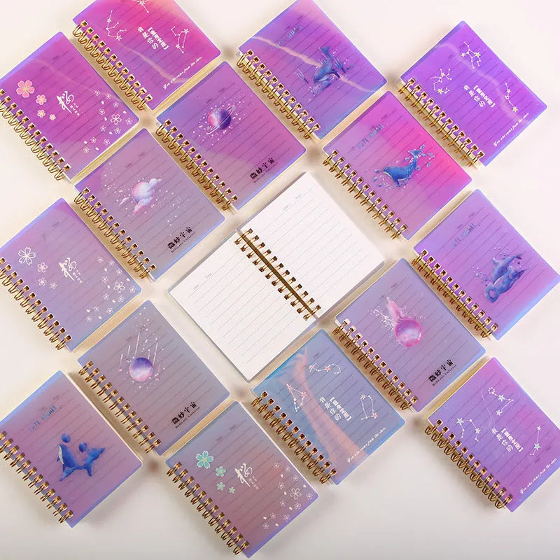 Set of four A7 spiral-bound pocket notebooks with rollover coils, showing Constellation, Sakura, Ocean, and Universe cover designs.