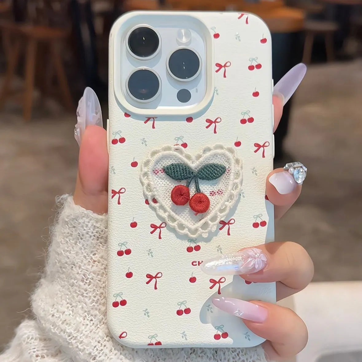 Cherry embroidered silicone iPhone case in litchi pattern white with three-dimensional raised embroidery design