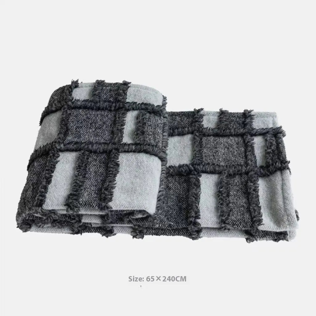 Modern minimalist grey and white plaid bed runner blanket set with pillow on a double bed.