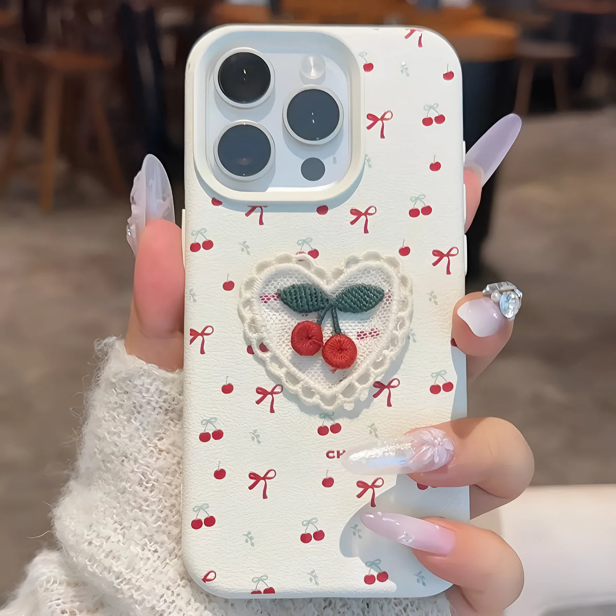 Cherry embroidered silicone iPhone case in litchi pattern white with three-dimensional raised embroidery design