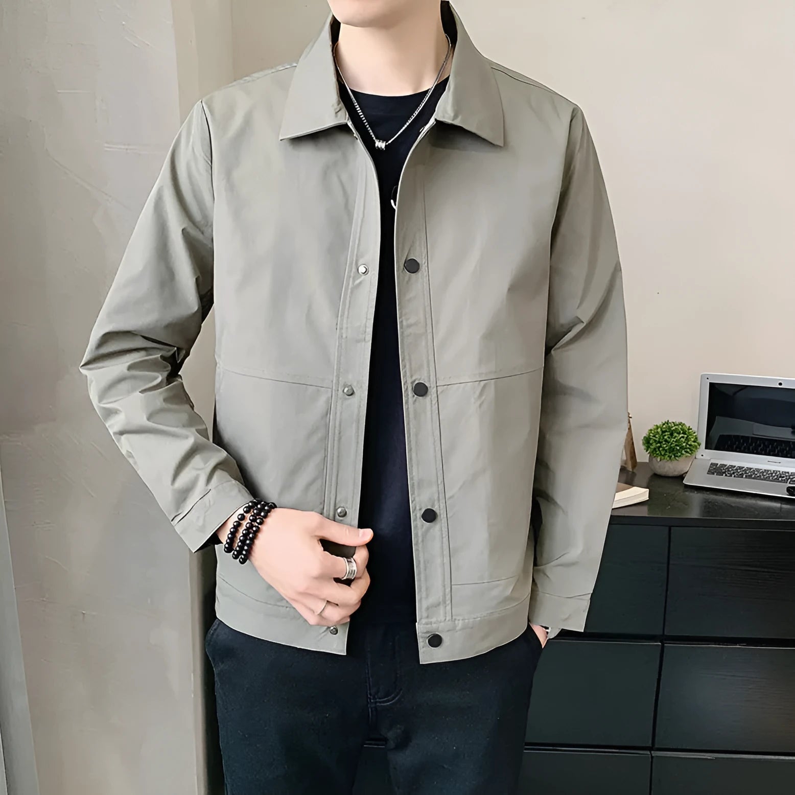 Man wearing a thin, grey, Korean-style long sleeve casual jacket for spring or autumn.
