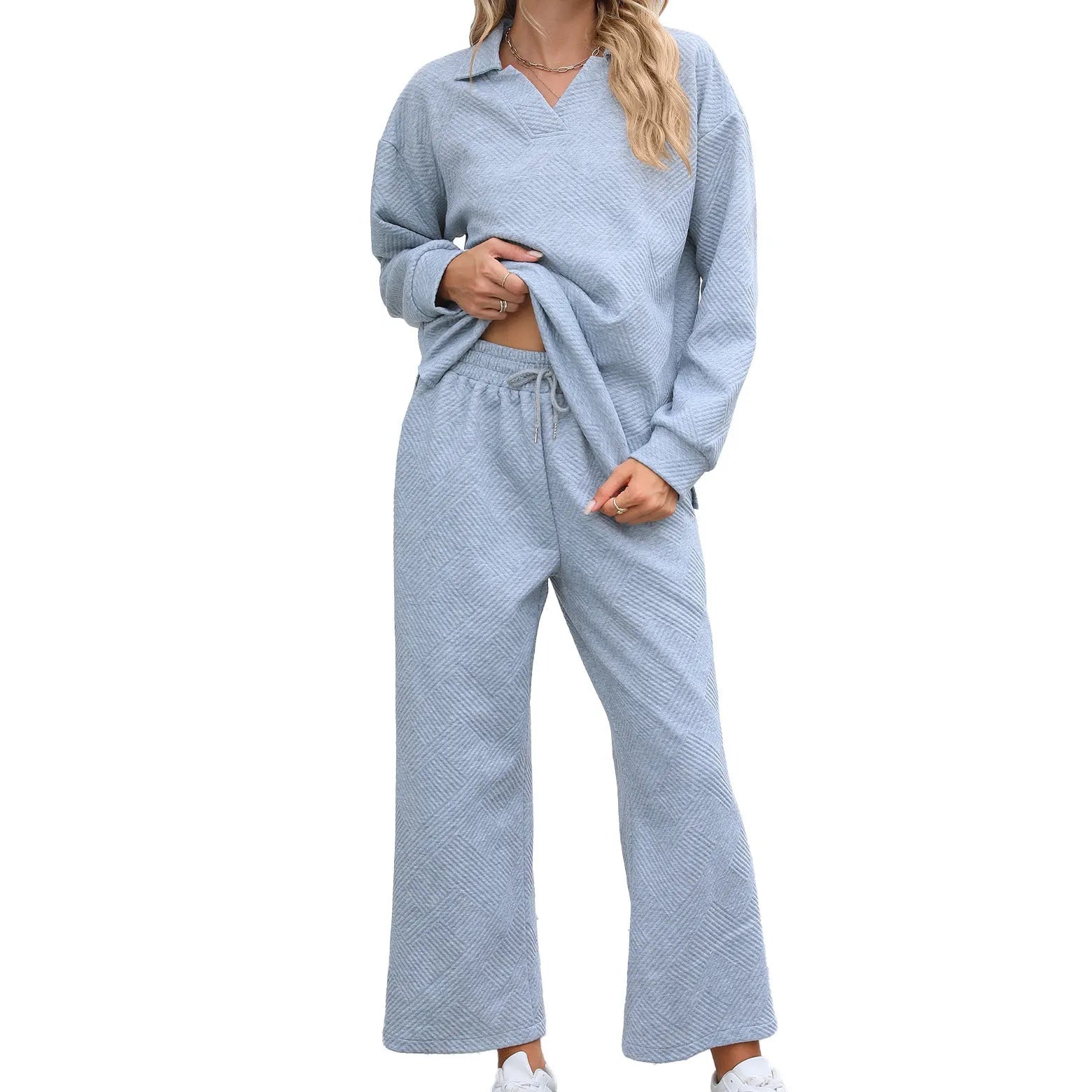 Women's solid colour knitted jacquard sweater and cropped pants suit in a geometric pattern.