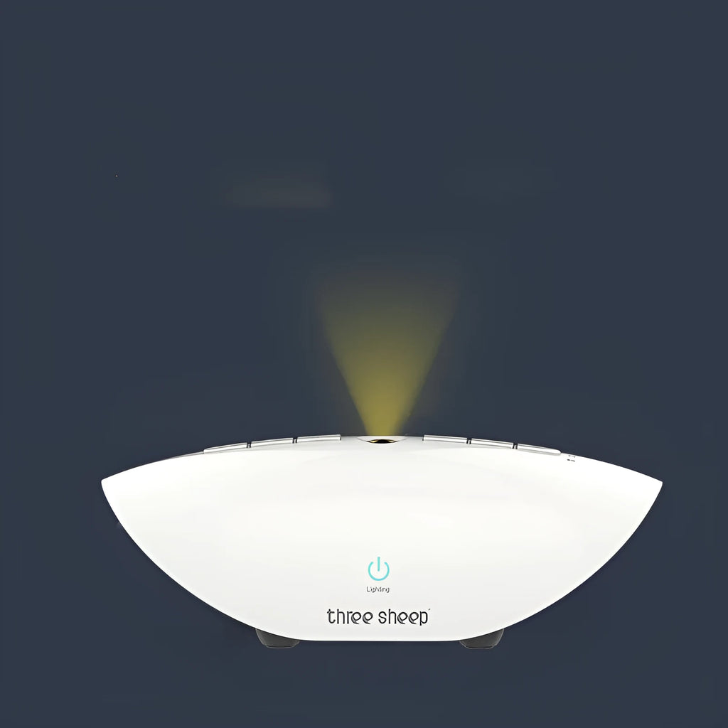 White plastic white noise sleep aid machine with mechanical buttons, 22cm tall.