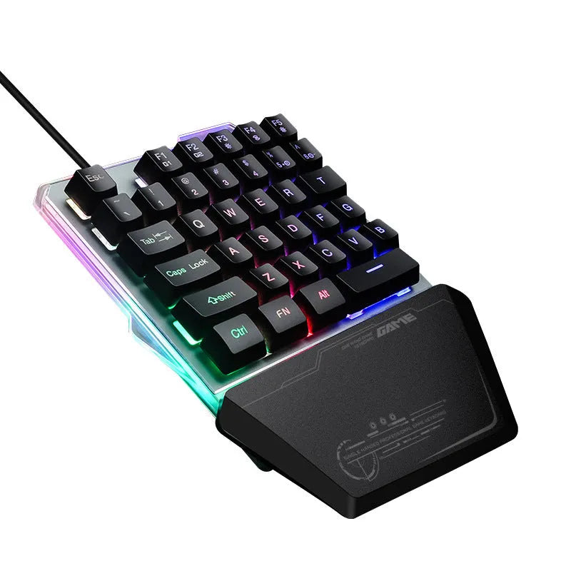 Black robotic one-handed mechanical keyboard with RGB backlit keys on a desk.