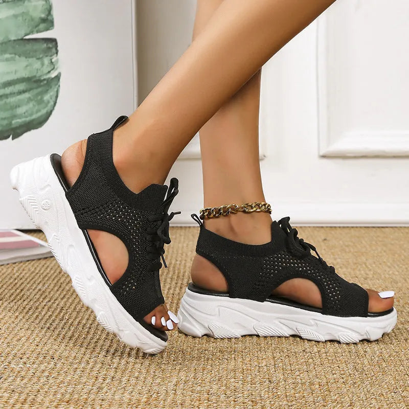 Lace-up sandals for women with thick rubber sole and mesh upper in orange colour, flat design