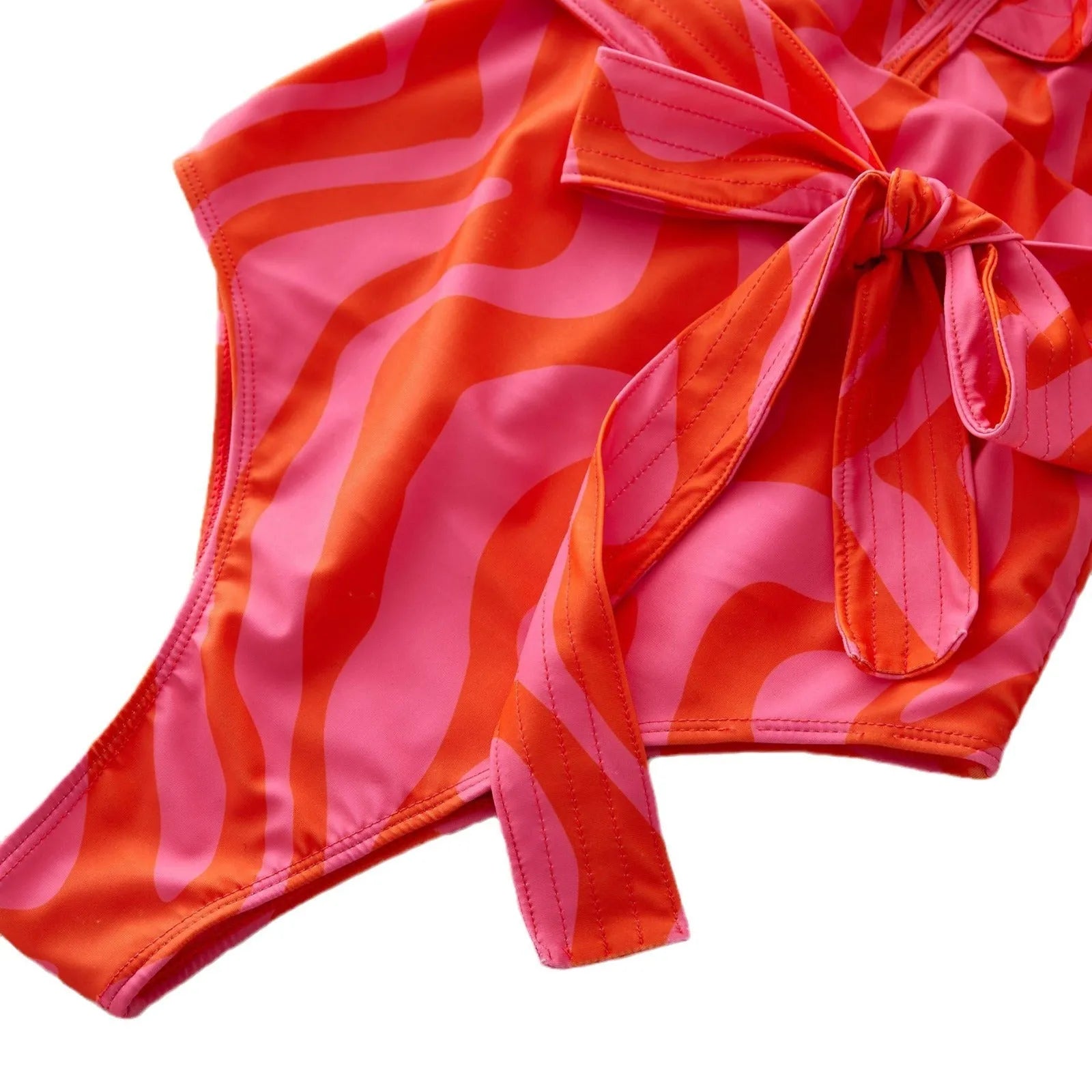 Women's printed one-piece swimsuit with ruffles on both shoulders and mesh stitching on the deep V-neck.