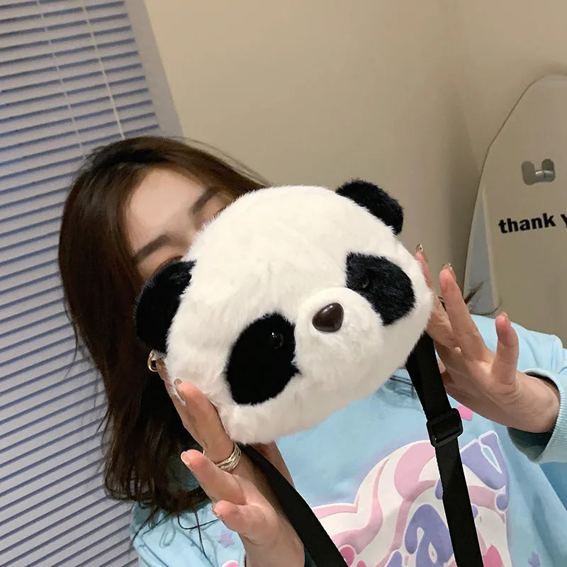 Soft plush panda head cylindrical crossbody bag with an outer sandwich pocket.